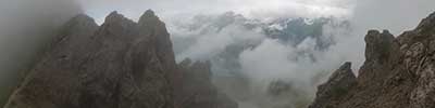 mist rises up the steep slopes of Casanna, Albula Alps, Zwitzerland