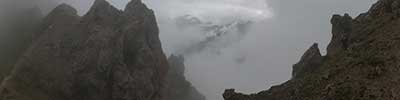 mist rises up the steep slopes of Casanna, Albula Alps, Zwitzerland